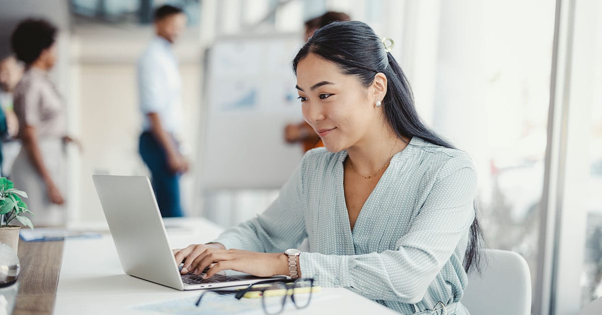 a person sitting at a table using a laptop