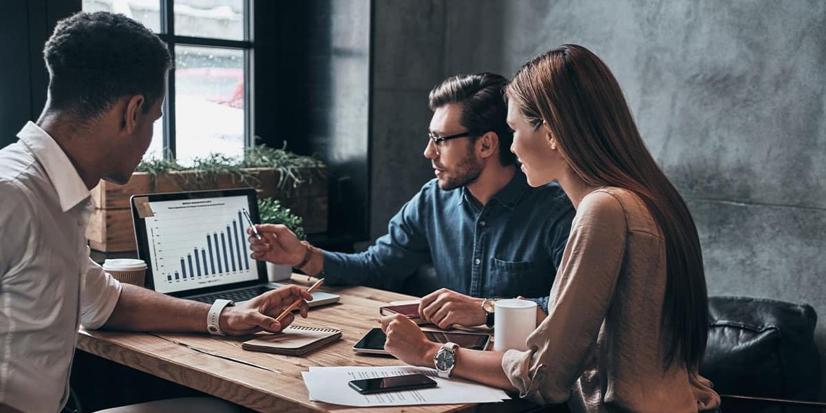 A Group Of People Sitting At A Table