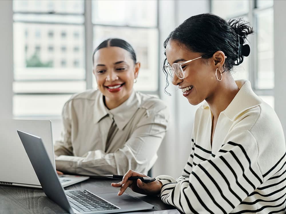 a group of people looking at a laptop